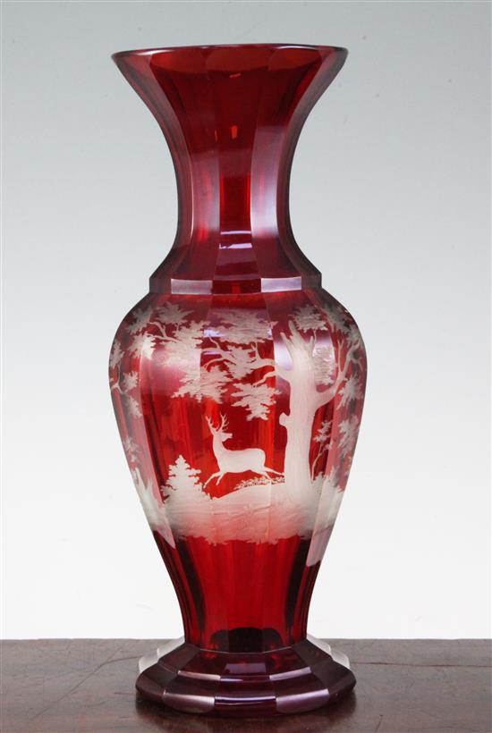 A Bohemian ruby glass multi-facetted baluster vase, late 19th century, 31.5cm